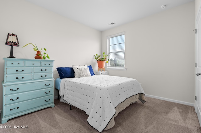 bedroom with carpet flooring and baseboards