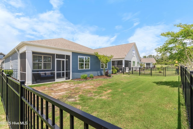 back of house with a sunroom and a shingled roof