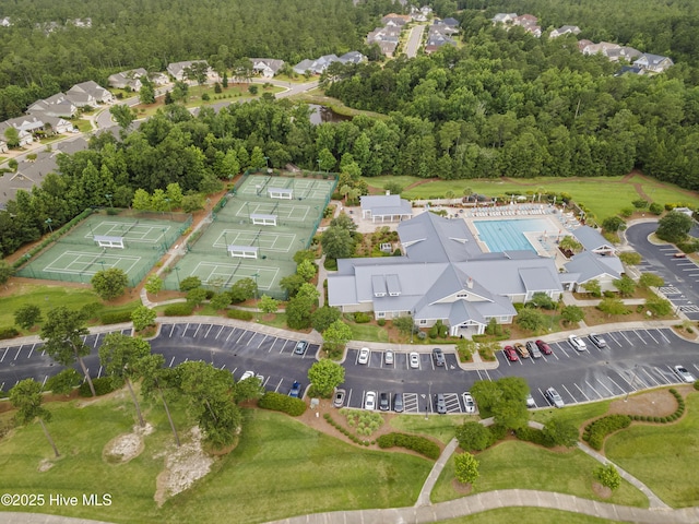 aerial view of property and surrounding area with a forest
