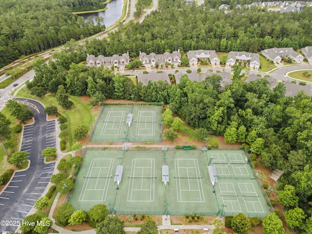 aerial perspective of suburban area with a nearby body of water
