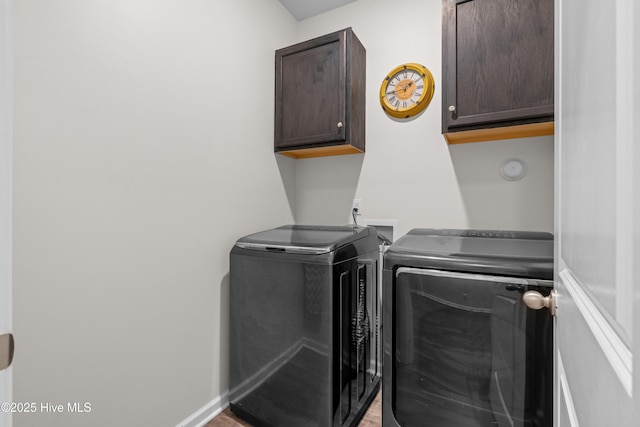 laundry room with separate washer and dryer, cabinet space, light wood-style floors, and baseboards