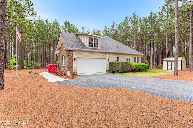 1 Eliot Ct, Jackson Springs, NC 27281 - view of side of home featuring asphalt driveway, a shingled roof, brick siding, and a garage