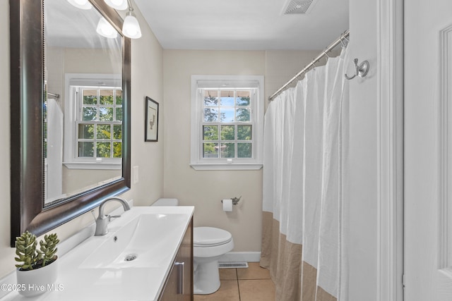 113 S Canal St, Whiteville, NC 28472 - bathroom with healthy amount of natural light, tile patterned floors, toilet, and vanity