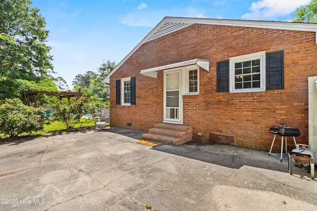113 S Canal St, Whiteville, NC 28472 - back of house with entry steps, brick siding, crawl space, and a patio