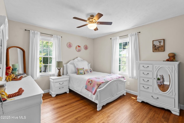 113 S Canal St, Whiteville, NC 28472 - bedroom with multiple windows, light wood-style flooring, baseboards, and ceiling fan