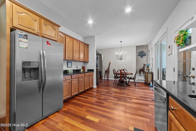171 Adams Ln, Washington, NC 27889 - kitchen with stainless steel appliances, dark wood-style floors, recessed lighting, dark stone counters, and brown cabinets