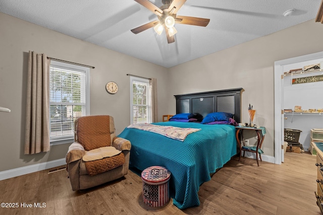 171 Adams Ln, Washington, NC 27889 - bedroom featuring wood finished floors, baseboards, a ceiling fan, and a spacious closet