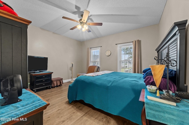 171 Adams Ln, Washington, NC 27889 - bedroom with light wood finished floors, a textured ceiling, a ceiling fan, vaulted ceiling, and baseboards