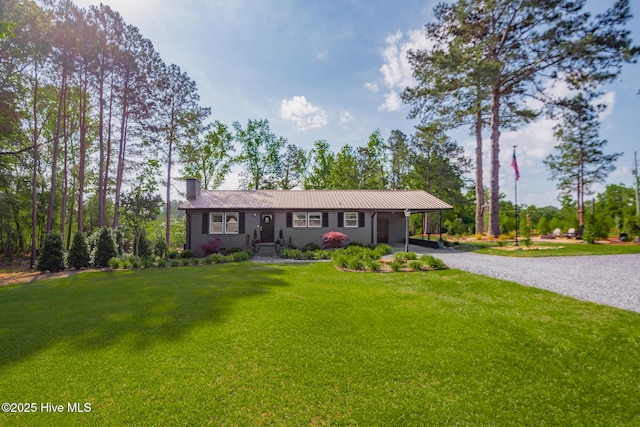 229 Rays Bridge Rd, Whispering Pines, NC 28327 - single story home with driveway, a chimney, a front yard, metal roof, and a carport