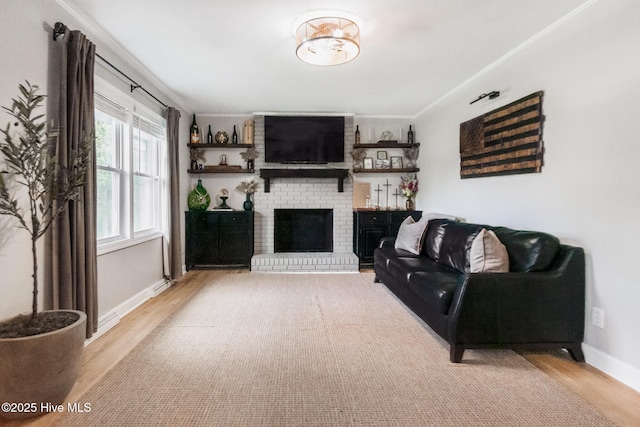 229 Rays Bridge Rd, Whispering Pines, NC 28327 - living room featuring wood finished floors, a brick fireplace, and baseboards
