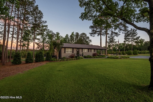 229 Rays Bridge Rd, Whispering Pines, NC 28327 - ranch-style home with a front yard, metal roof, and a chimney