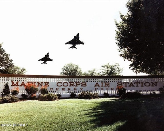 community sign featuring a lawn