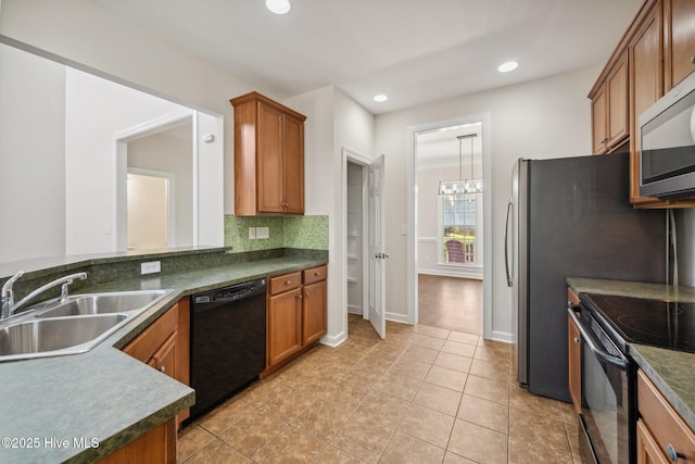 870 Wine Cellar Cir, Wilmington, NC 28411 - kitchen featuring black appliances, a sink, brown cabinets, dark countertops, and recessed lighting