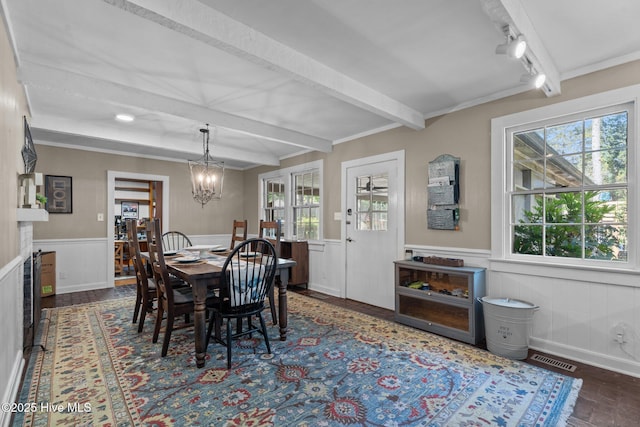 224 Westview Park Dr, Rocky Mount, NC 27804 - dining area with beam ceiling, a wainscoted wall, a chandelier, and dark wood finished floors