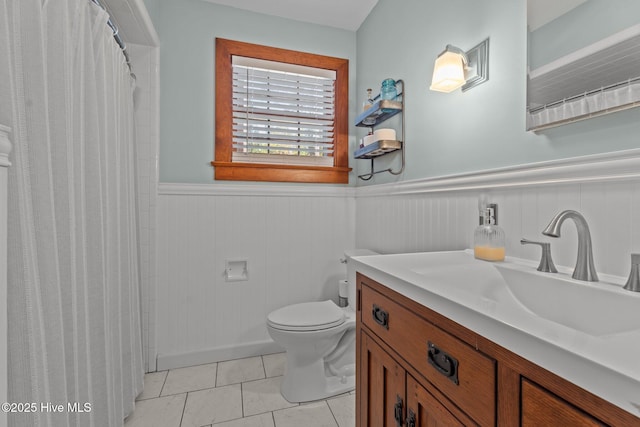 224 Westview Park Dr, Rocky Mount, NC 27804 - bathroom featuring wainscoting, toilet, vanity, tile patterned floors, and a shower with curtain