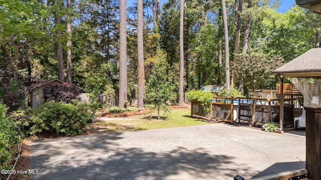 224 Westview Park Dr, Rocky Mount, NC 27804 - view of patio / terrace featuring a shed, an outbuilding, view of scattered trees, and a deck