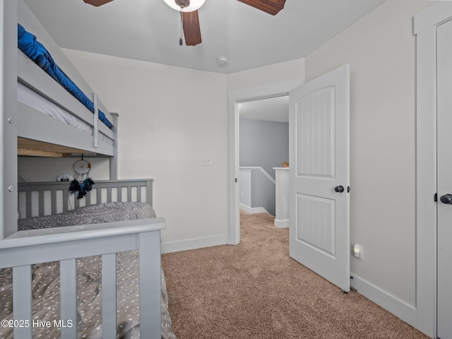 unfurnished bedroom with carpet, baseboards, and ceiling fan