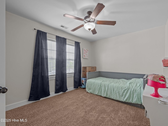 carpeted bedroom featuring ceiling fan and baseboards