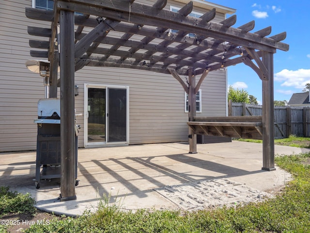 view of patio with a pergola and fence