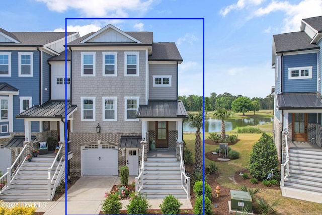 multi unit property with stairs, a water view, brick siding, and concrete driveway