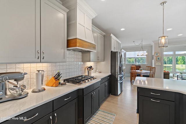 kitchen featuring stainless steel appliances, custom range hood, light wood finished floors, tasteful backsplash, and recessed lighting