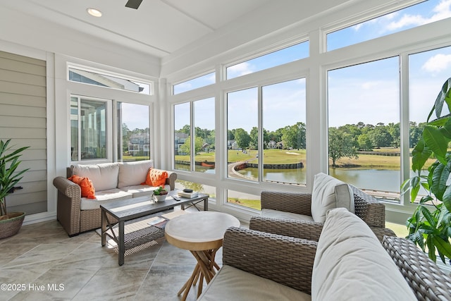 sunroom / solarium featuring plenty of natural light, a water view, outdoor lounge area, view of scattered trees, and recessed lighting