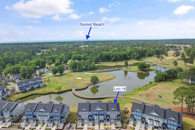 aerial view of residential area with a nearby body of water and a local golf course