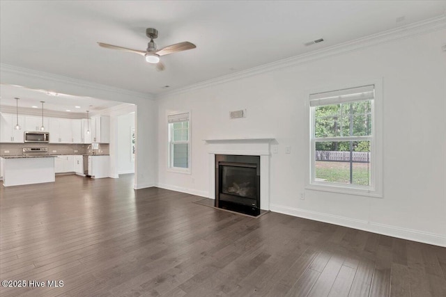 107 Meadowview Pl, Whispering Pines, NC 28327 - unfurnished living room with ceiling fan, dark wood-style floors, a glass covered fireplace, and crown molding