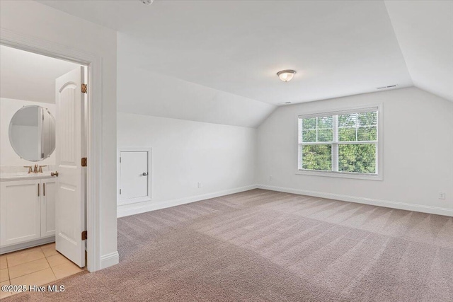 107 Meadowview Pl, Whispering Pines, NC 28327 - additional living space with vaulted ceiling and light colored carpet