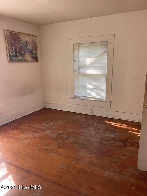 spare room with wood finished floors and baseboards