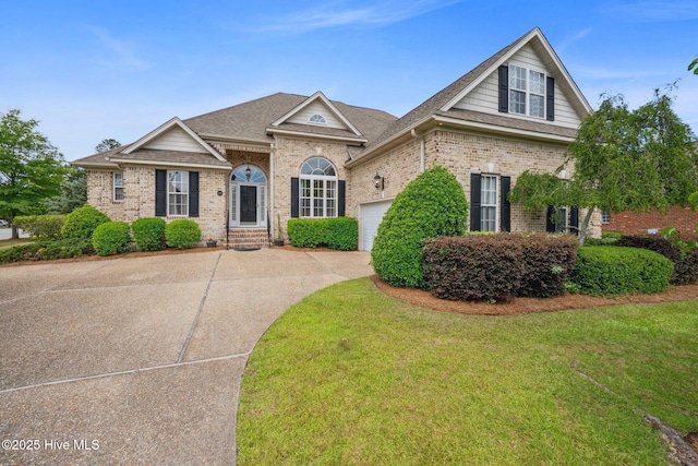 view of front of property with concrete driveway, a garage, brick siding, and a shingled roof