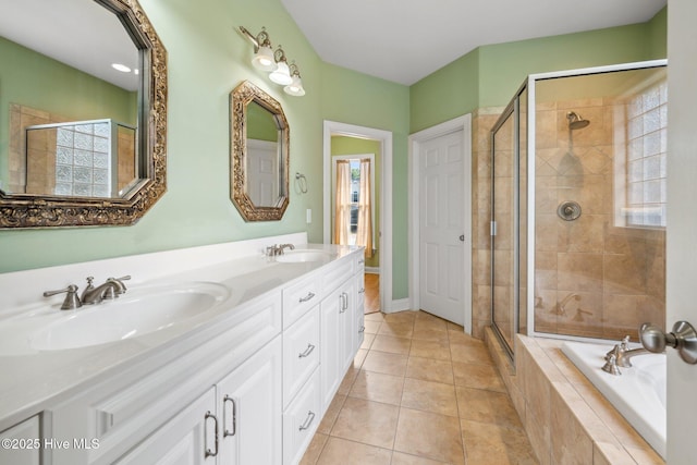 bathroom featuring plenty of natural light, a shower stall, tiled bath, and tile patterned flooring