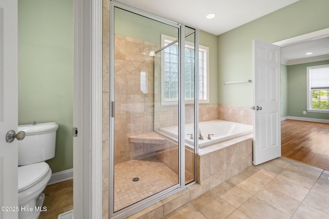 bathroom with a stall shower, a bath, toilet, tile patterned floors, and recessed lighting
