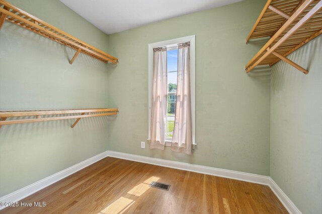 spacious closet featuring wood finished floors