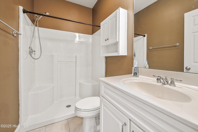 bathroom featuring tile patterned flooring, a shower, toilet, and vanity