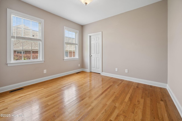 unfurnished room featuring light wood-style floors and baseboards