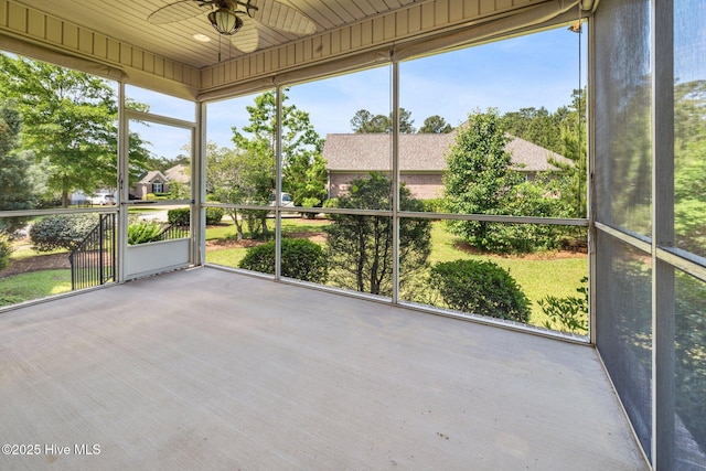 unfurnished sunroom with a ceiling fan and healthy amount of natural light
