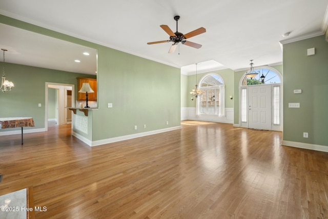 unfurnished living room featuring a chandelier, ornamental molding, wood finished floors, a ceiling fan, and recessed lighting