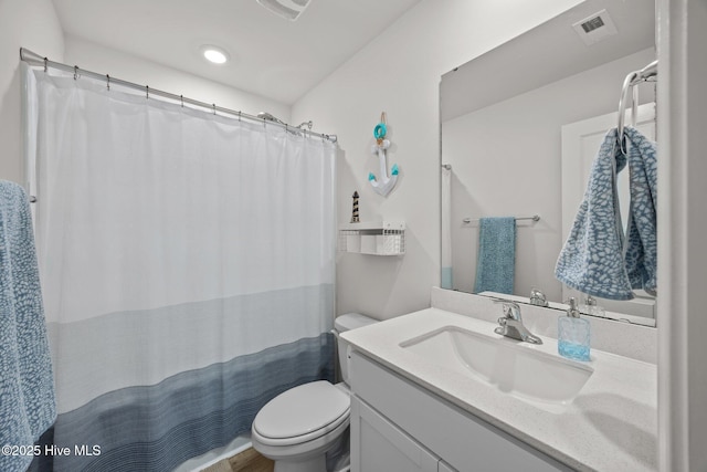 bathroom with toilet, vanity, and curtained shower
