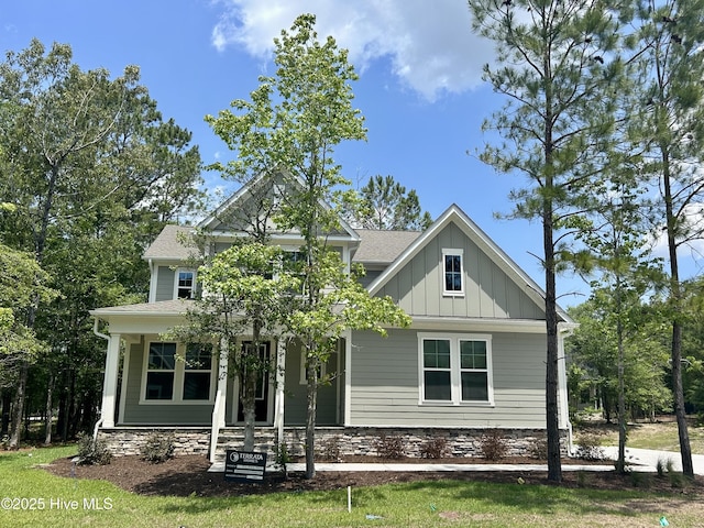 778 Hollybriar Loop Rd SE, Bolivia, NC 28422 - view of front of home with board and batten siding, covered porch, and a shingled roof