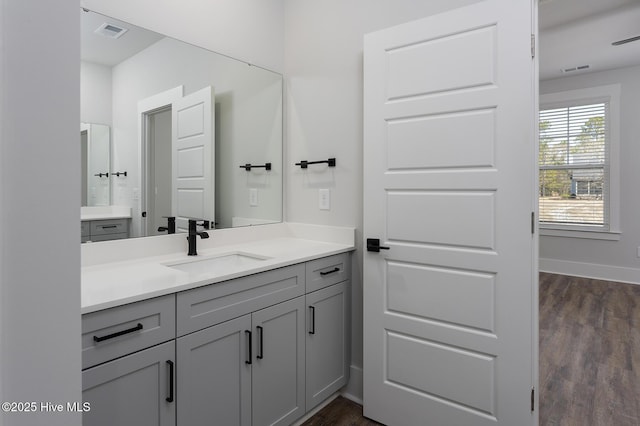 778 Hollybriar Loop Rd SE, Bolivia, NC 28422 - bathroom featuring vanity, wood finished floors, and baseboards