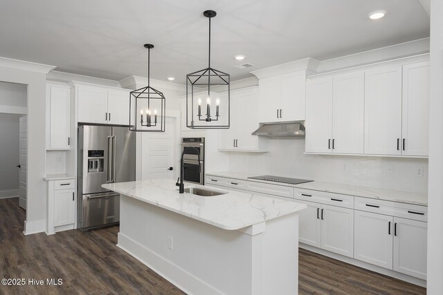 778 Hollybriar Loop Rd SE, Bolivia, NC 28422 - kitchen featuring appliances with stainless steel finishes, a sink, under cabinet range hood, dark wood-style floors, and a kitchen island with sink