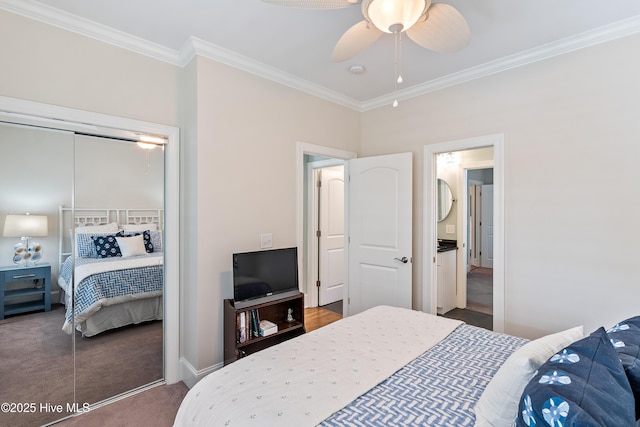 carpeted bedroom with ornamental molding, a closet, a ceiling fan, and baseboards