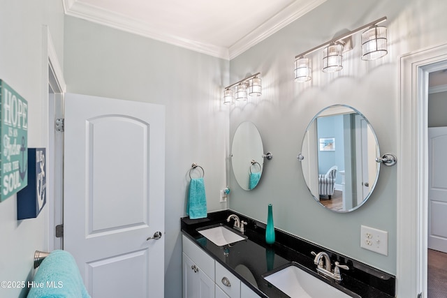 bathroom featuring crown molding and double vanity