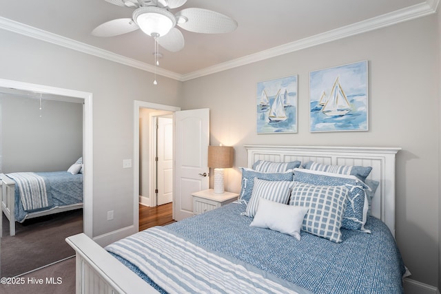 bedroom featuring ornamental molding, a ceiling fan, dark colored carpet, and baseboards