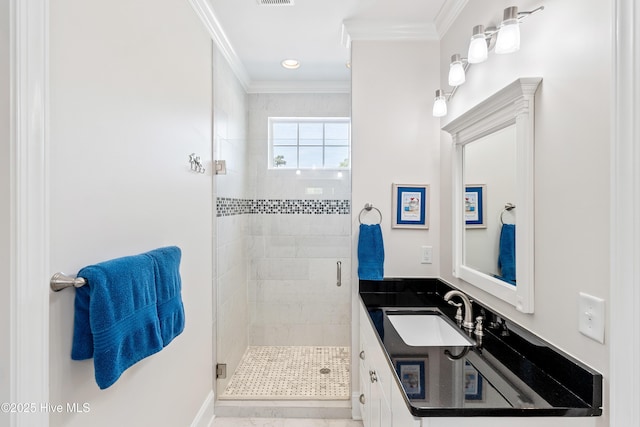 bathroom featuring a stall shower, ornamental molding, and vanity