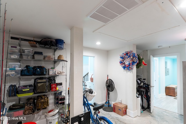 workout room featuring attic access and baseboards