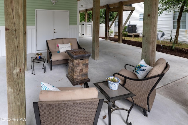 view of patio with outdoor lounge area, fence, and central air condition unit