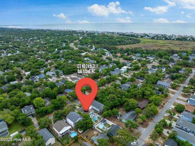 aerial perspective of suburban area with a nearby body of water