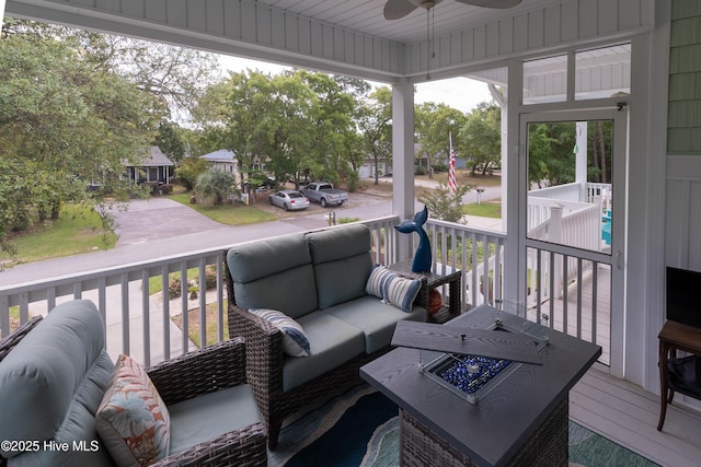 deck featuring a ceiling fan, outdoor lounge area, and a porch